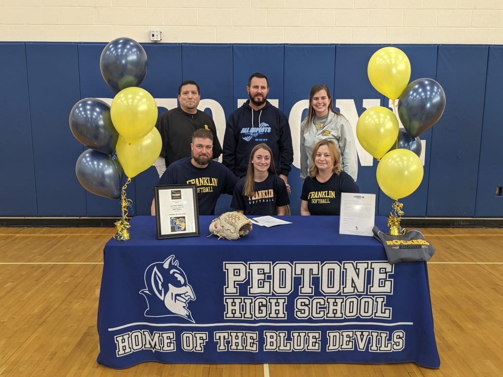 Alyssa Pasch, along with her family, and coaches, pose at her recent college signing.