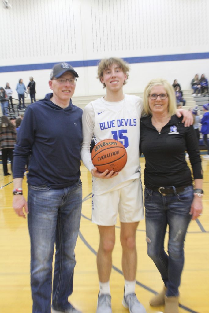Mason Kibelkis and his parents at the February 15 game. – Photo by James Piacentini.