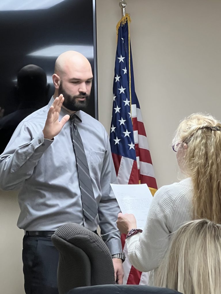 Officer Kenneth Hopman being sworn in at the February 28th board meeting. Photo by Andrea Arens.