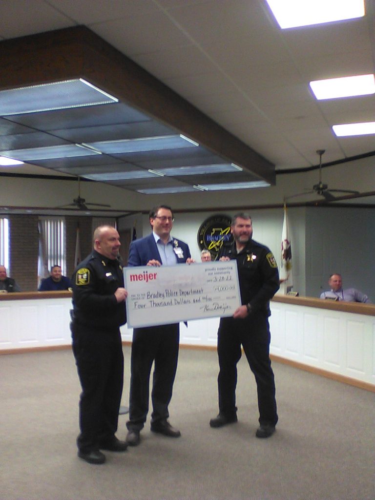 Bradley Police Chief Don Barber eceives donation check from Meijer Manager Dan Komer.