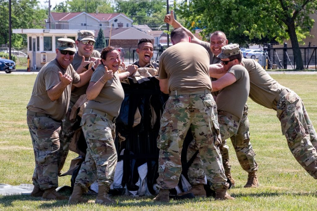 Master Sgt. Thelma Barrios, brigade senior human resource noncommissioned officer for the 108th Sustainment Brigade, gives a thumbs up as she and her teammates start to put together a tent during a training exercise at North Riverside, on June 10. Barrios was selected as a national 2022 Latina-Style Distinguished Military Service Award recipient -one of only 21 service members selected for the honor this year. –U.S. Army photo courtesy of Army Master Sgt. Thelma Barrios.