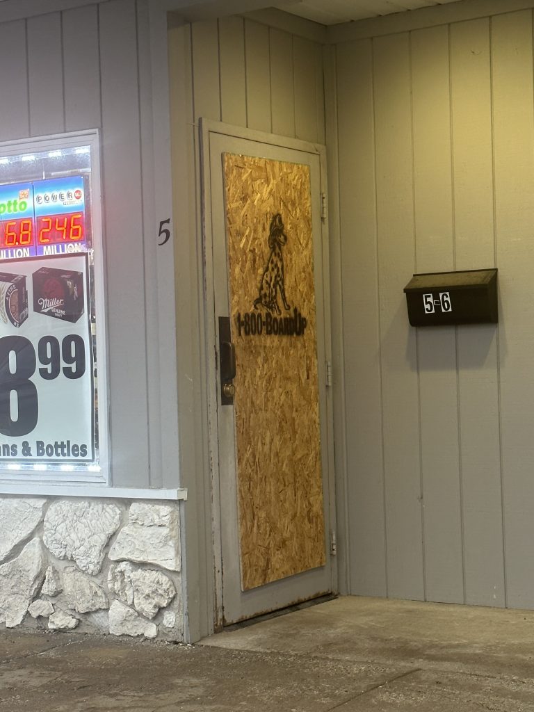 The door to Peotone Tobacco & Liquor is boarded after offenders smashed it on December 30th. Photo by Andrea Arens.