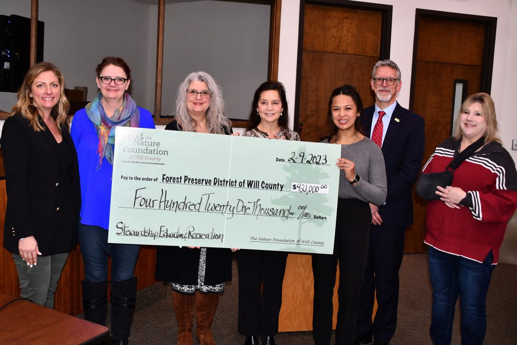 The Nature Foundation of Will County representatives presented a donation check at the February 9 Forest Preserve District of Will County Board of Commissioners meeting. Pictured, left to right, are: Foundation Chairperson Ragan Pattison, Forest Preserve Board President Meta Mueller, Foundation Executive Director Cynthia Harn, Foundation Directors and Forest Preserve Commissioners Julie Berkowicz and Elnalyn Costa, Forest Preserve Executive Director Ralph Schultz, and Forest Preserve Board Vice President Annette Parker. –Forest Preserve photo, Glenn P. Knoblock.