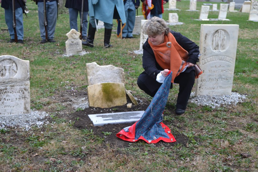 Pictured: Rachel White unveiling the new headstone. Photo by Karen Haave.