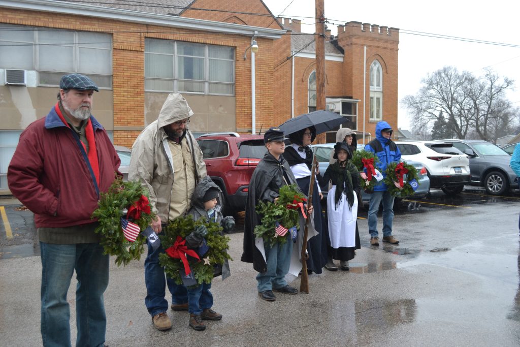 Weather dampened the Wreaths Across America ceremony but did not stop it. –Photo by Karen Haave.