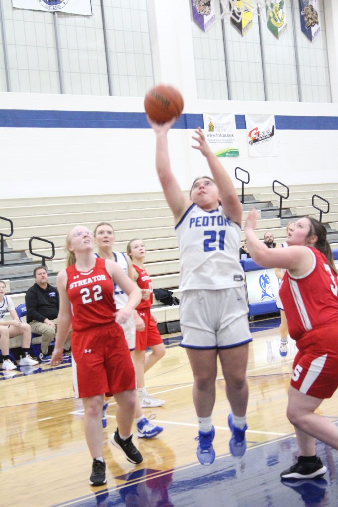 Emma Iozzo, #21, showed great determination as she went for the basket. –Photo by Jim Piacentini.