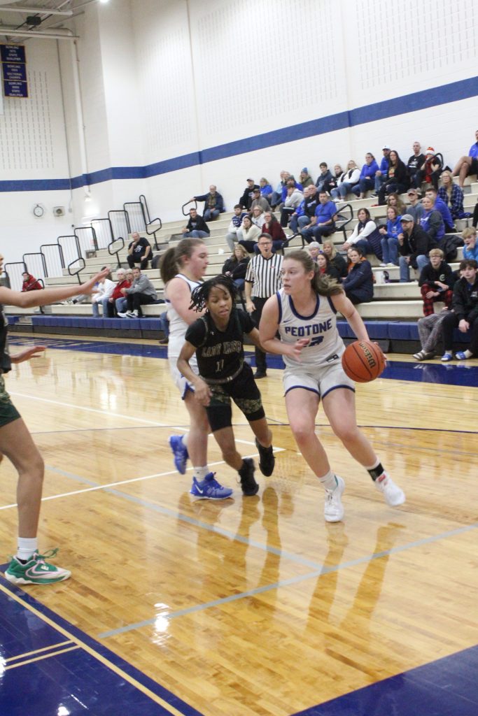 Madi Schroeder, #22 and the contest's high scorer for the Blue Devils, definitely knows where she's going under the hoop. –Photo by Jim Piacentini.