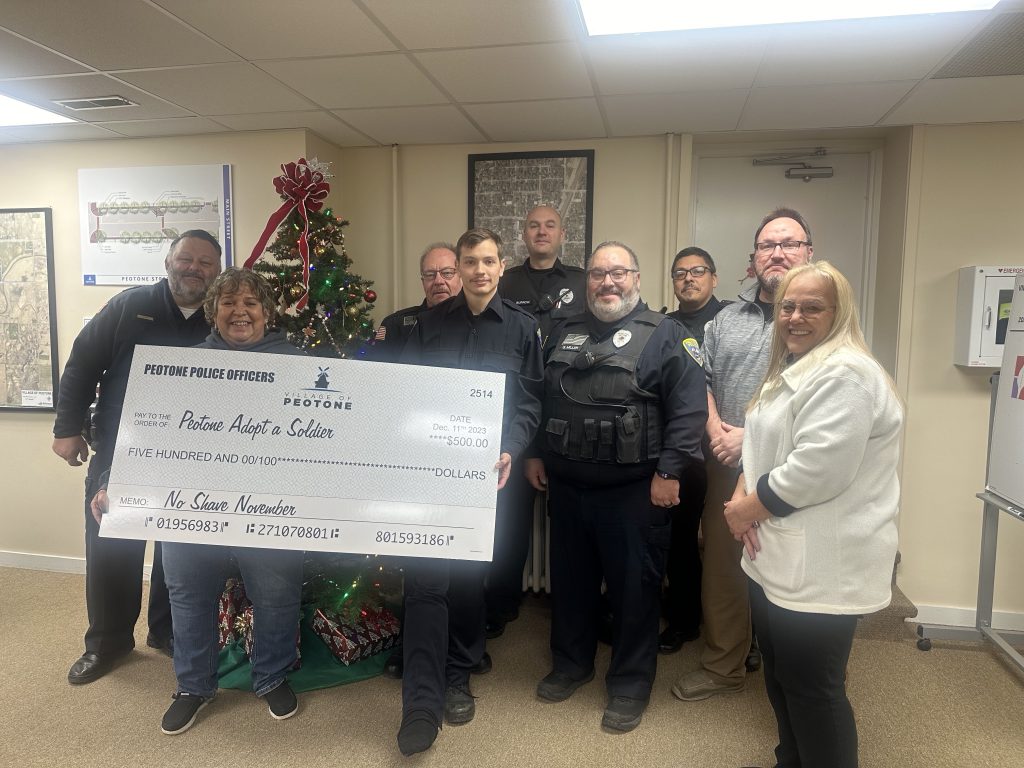 The Peotone Police Department participated in No Shave November and presented Sue Wackerlin of Adopt a Soldier with a $500 check. Photo by Andrea Arens.
