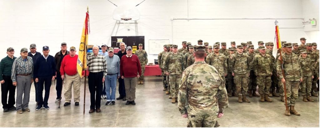 Vietnam Veterans, of the Illinois Army National Guard's 126th Supply and Services Co. of Quincy, stand in formation with soldiers of the modern 126th Quartermaster Co. on December 17 as part of the unit's family holiday party. The veterans presented the modern unit with a plaque that will hang for perpetuity in the Illinois Army National Guard's Quincy Armory, memorializing the service of the only Illinois Army National Guard unit to deploy to Vietnam. The unit deployed in September 1968 and returned to a parade and celebration in Quincy in August 1969. –Photo submitted.