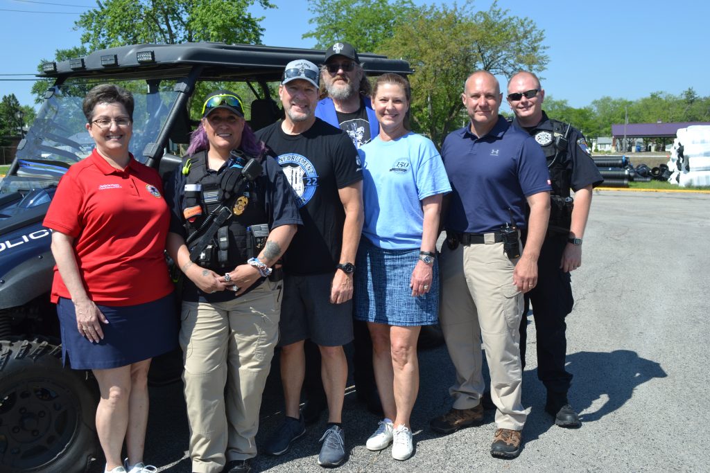 Some of the volunteers and supporters for L.E.A.D. were in the line-up for the Blue Line Parade on Saturday in Monee, including (from left) State Rep. Jackie Haas, Tracey Henson, Monee Police Chief Scott Koerner, Dr. Therese Bogs - Mayor of Monee, Deputy Chief Anthony Lazzaroni, Patrol Officer Jared Hoekstra, and event founder John Henson.  –Photo by Karen Haave.