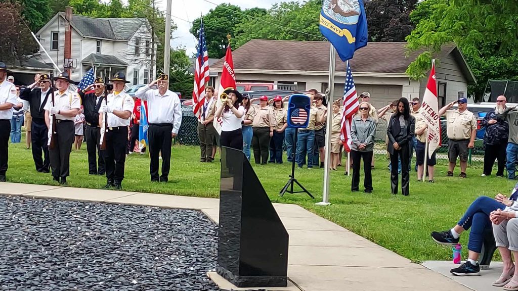 Flags flutter, a bugler plays, and residents remember on Memorial Day, May 27, in Manteno. –Photo by Diane Gerber.