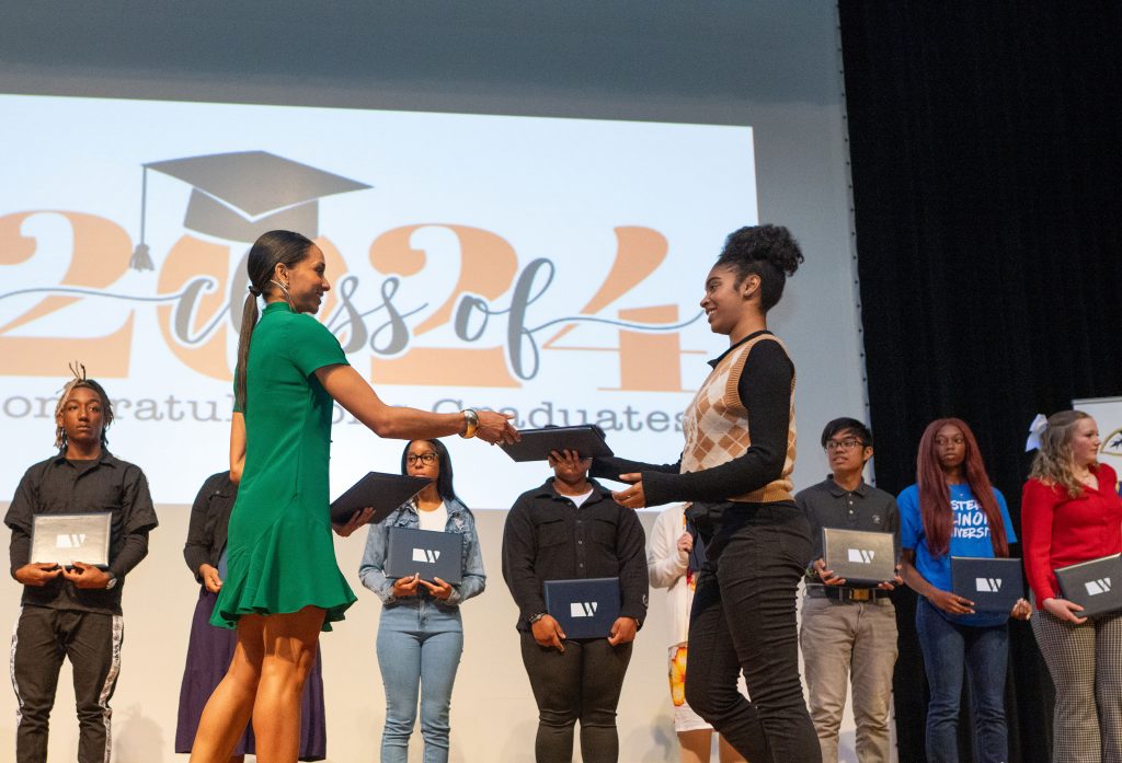 Trinity Watts, a senior at Crete-Monee High School, receives a scholarship from the Witherite Law Group, presented by Maya Hightower on May 9. –Photo submitted.